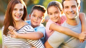 Outdoor Portrait Of Family Having Fun In Park