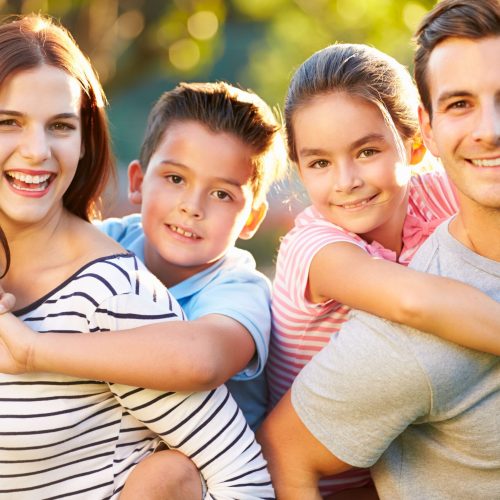 Outdoor Portrait Of Family Having Fun In Park